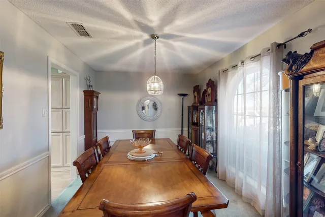 a living room with furniture a fireplace and a chandelier