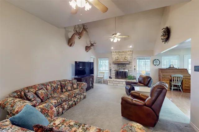 a living room with furniture a fireplace and a flat screen tv