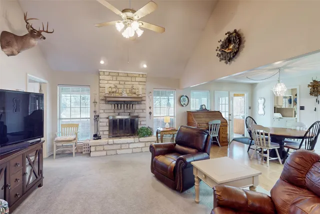 a living room with furniture a fireplace and a large window