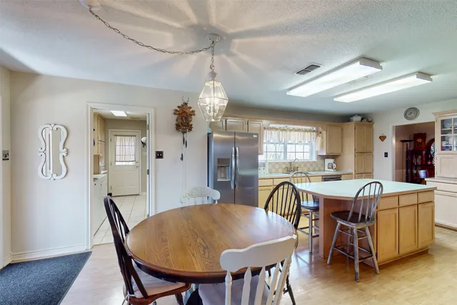 a large kitchen with stainless steel appliances granite countertop a large window a oven and a large island