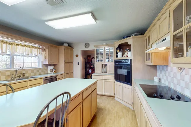 a kitchen with a stove and a refrigerator