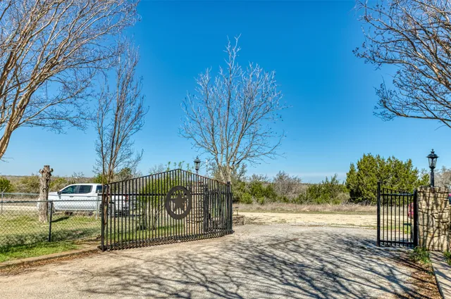 a view of a yard with wooden fence