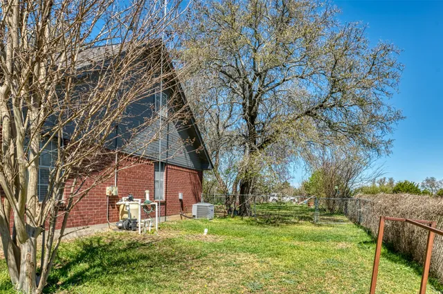 a view of a house with backyard porch and sitting area