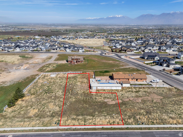 296 West Olympic Lane, Unit 2 Elk Ridge, UT 84651 - Photo 2 of 14 Aerial perspective of suburban area featuring property boundaries highlighted and a mountainous background