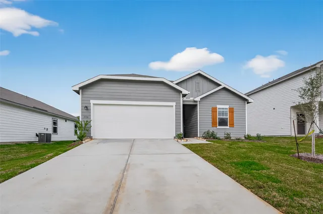 a view of a house with a yard and potted plants