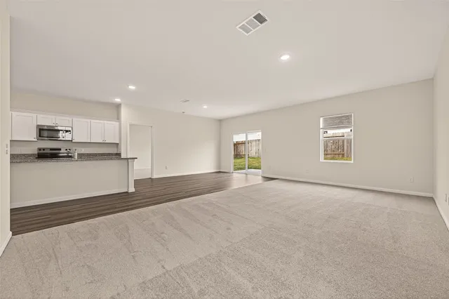 a view of a kitchen with a sink and a refrigerator
