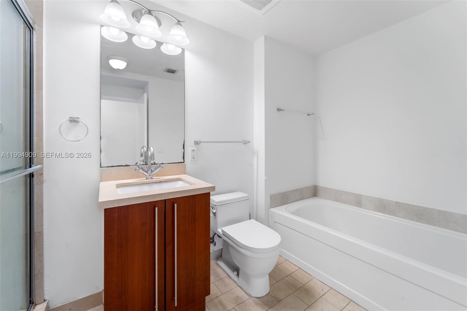 79 Southwest 12th Street, Unit 2108S Miami, FL 33130 - Photo 11 of 16 a bathroom with a sink toilet and shower