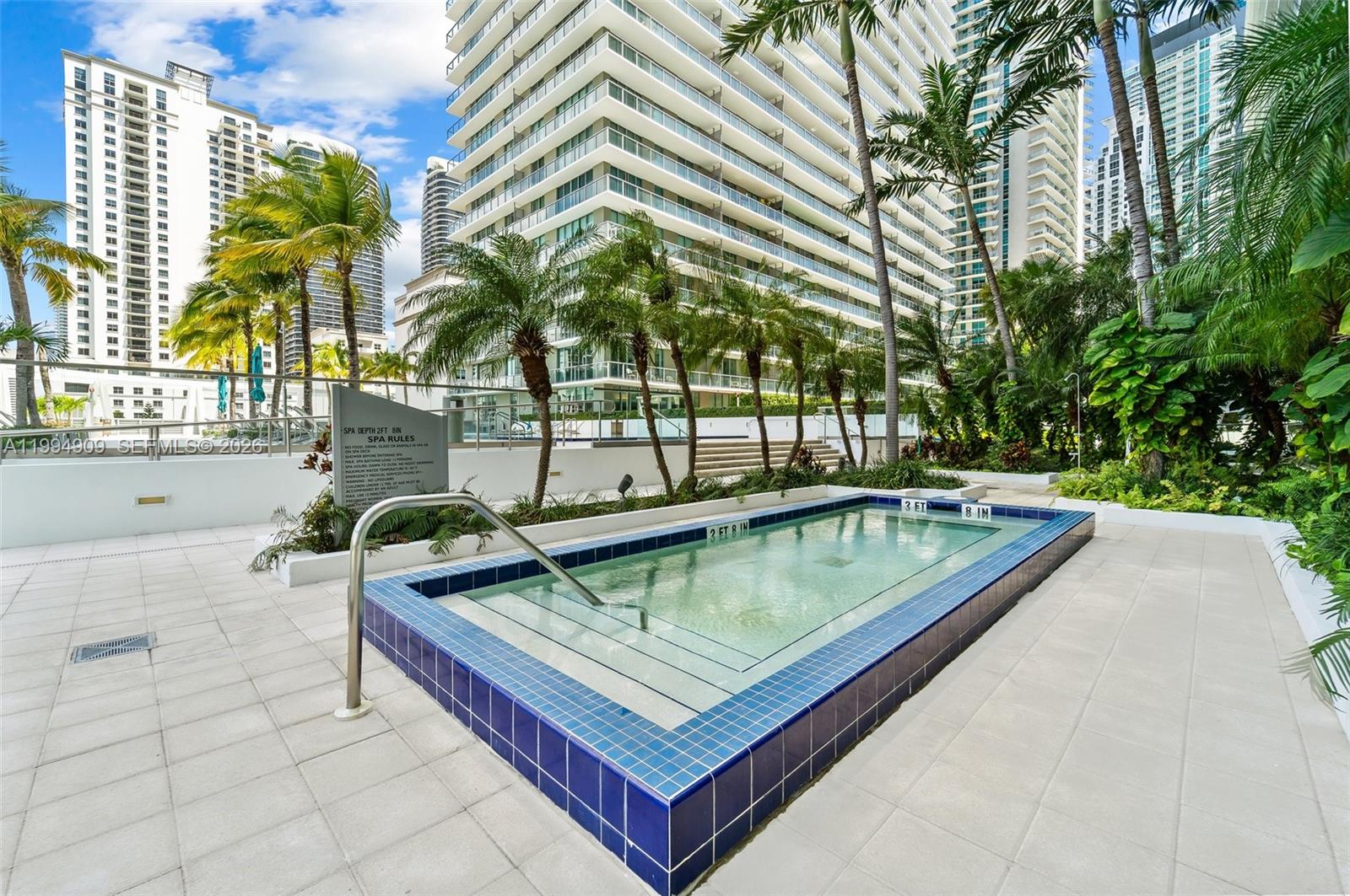 79 Southwest 12th Street, Unit 2108S Miami, FL 33130 - Photo 14 of 16 a view of a swimming pool with a lounge chairs