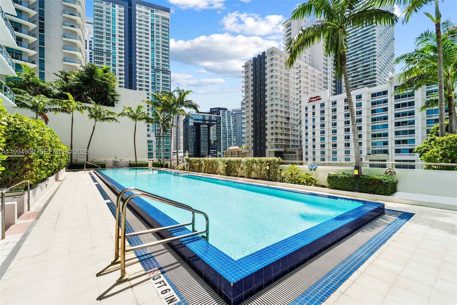 79 Southwest 12th Street, Unit 2108S Miami, FL 33130 - Photo 15 of 16 a view of a swimming pool with chairs