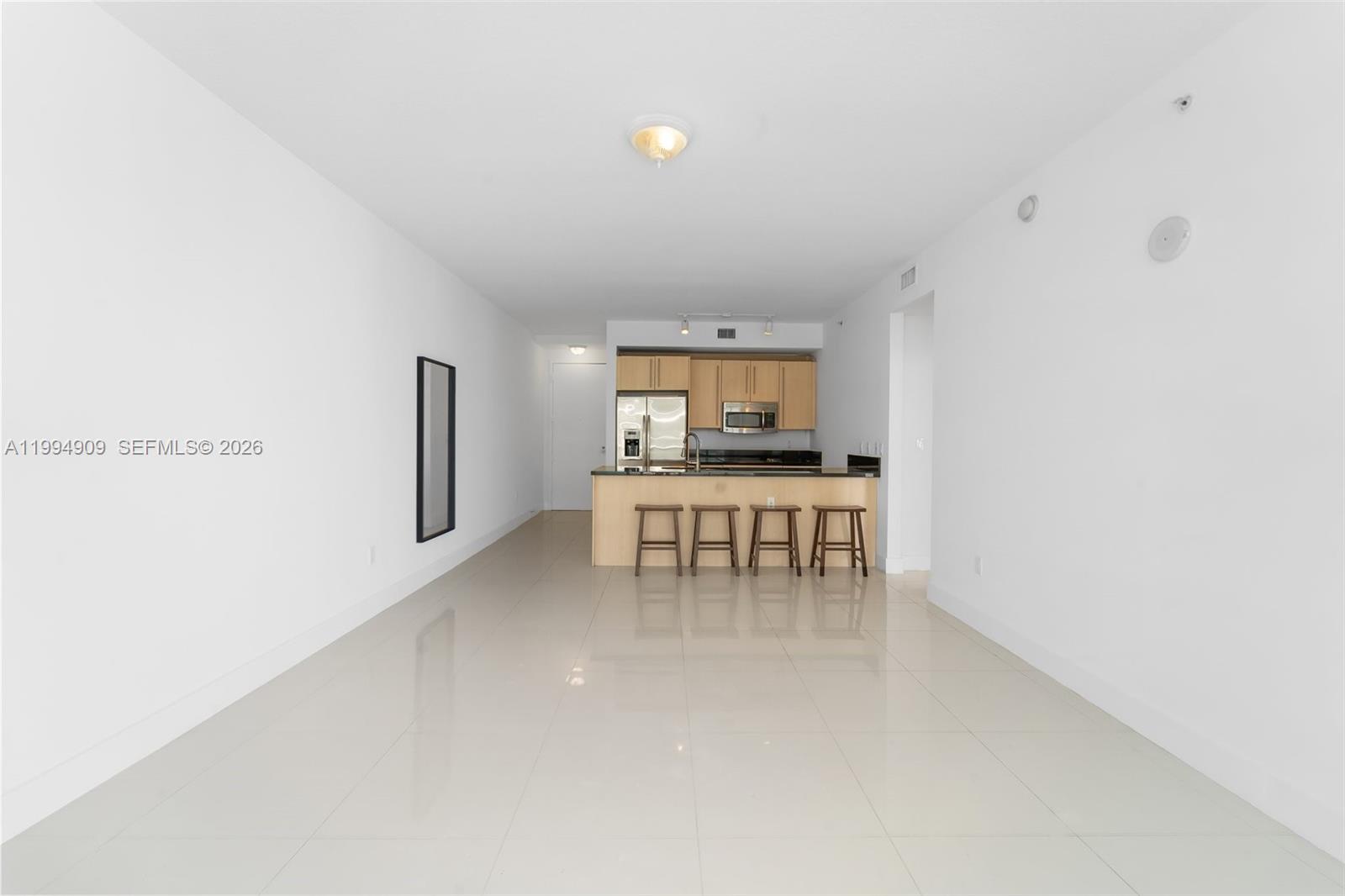 79 Southwest 12th Street, Unit 2108S Miami, FL 33130 - Photo 2 of 16 a dining room with furniture and a window