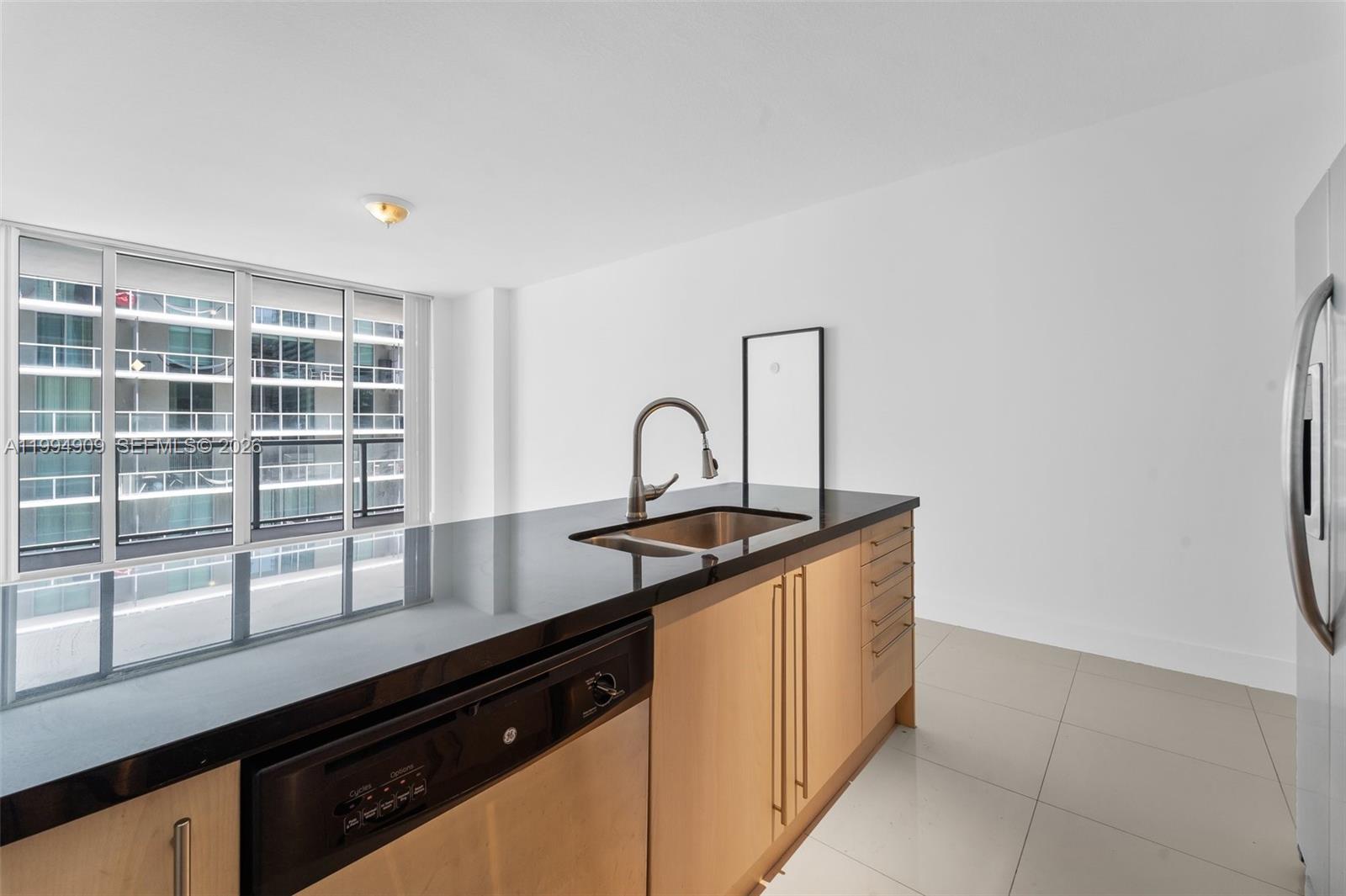79 Southwest 12th Street, Unit 2108S Miami, FL 33130 - Photo 4 of 16 a view of a kitchen counter top space and cabinets