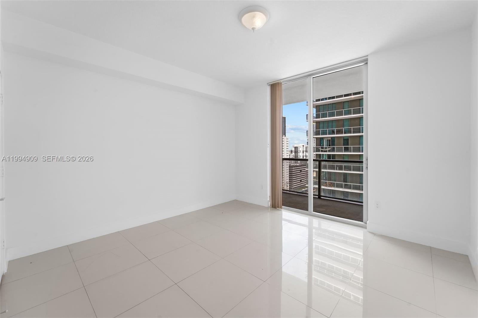 79 Southwest 12th Street, Unit 2108S Miami, FL 33130 - Photo 7 of 16 a view of an empty room with a window
