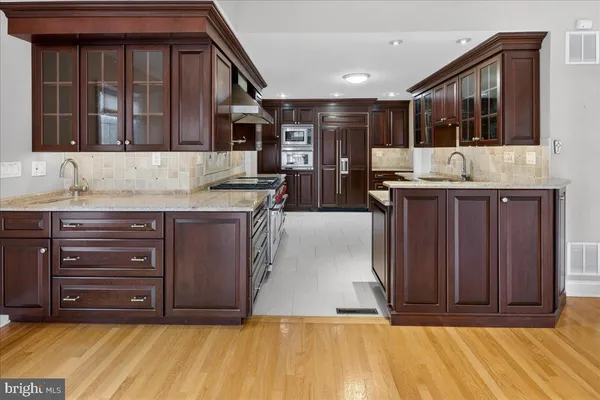 a kitchen with a sink and a wooden cabinets