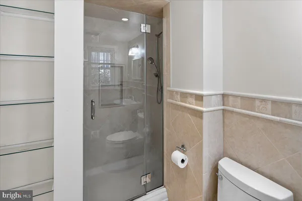 a bathroom with a shower and toilet