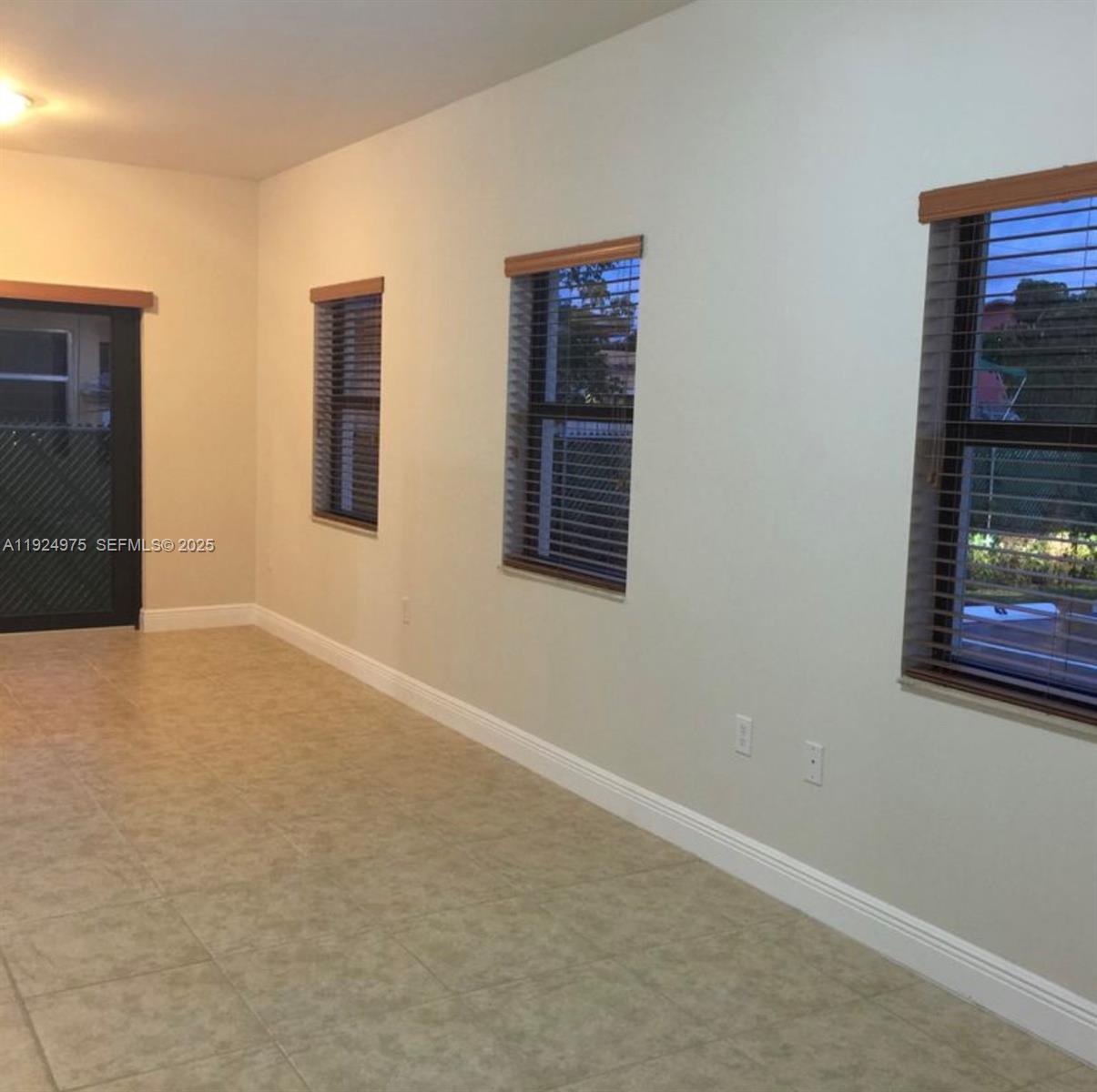 41 West 14th Street, Unit 1 Hialeah, FL 33010 - Photo 4 of 15 a view of an empty room with a window