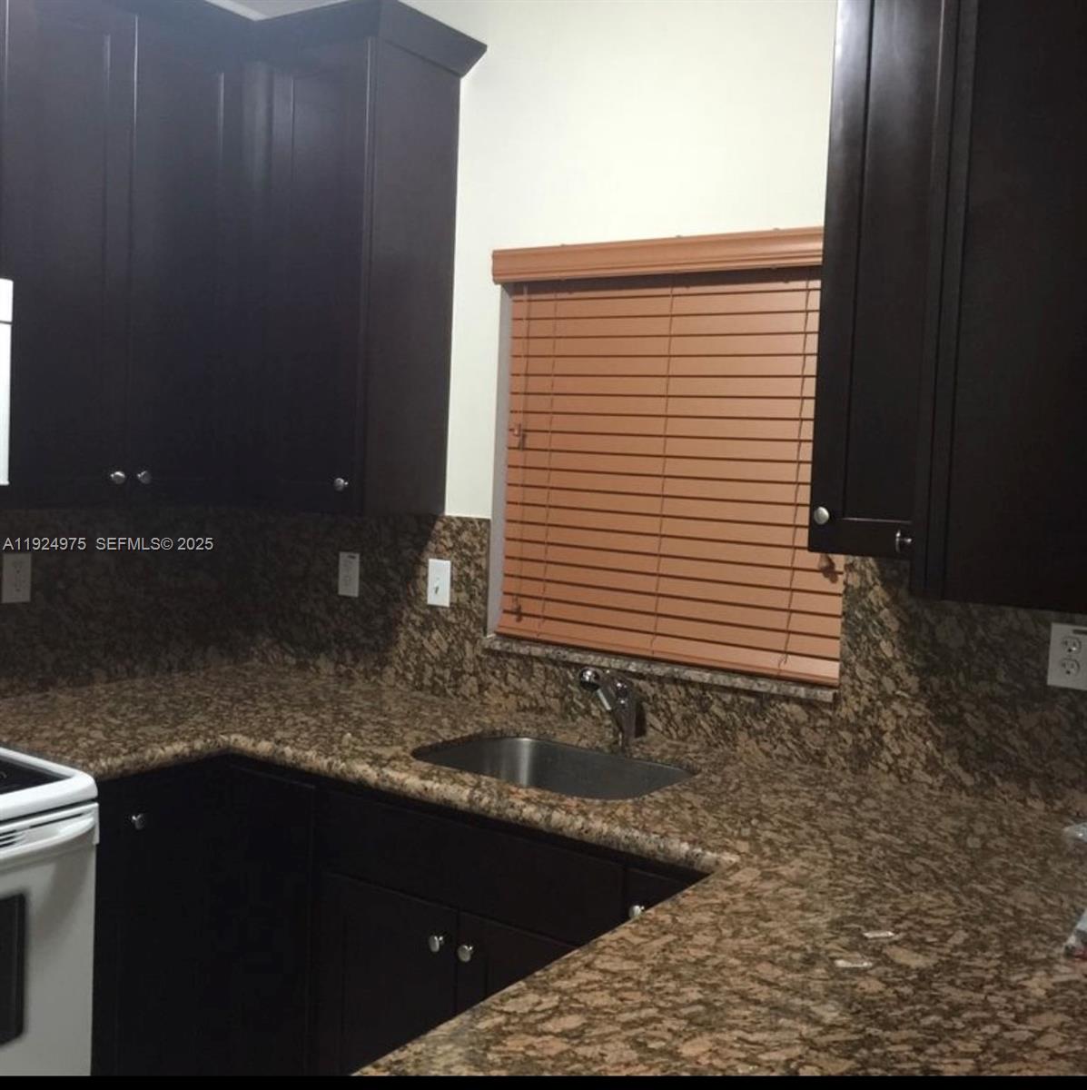 41 West 14th Street, Unit 1 Hialeah, FL 33010 - Photo 5 of 15 a kitchen with a sink and cabinets