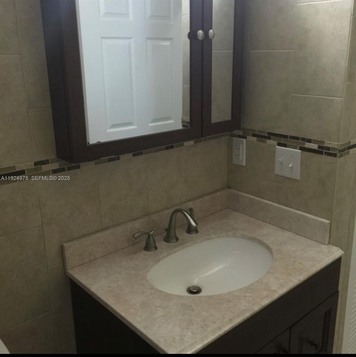 41 West 14th Street, Unit 1 Hialeah, FL 33010 - Photo 7 of 15 a bathroom with a sink and vanity