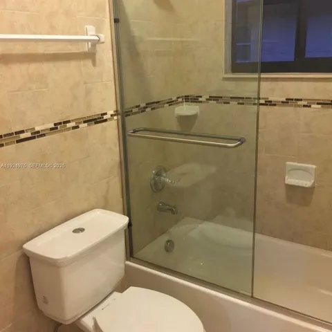 a bathroom with a shower and a sink