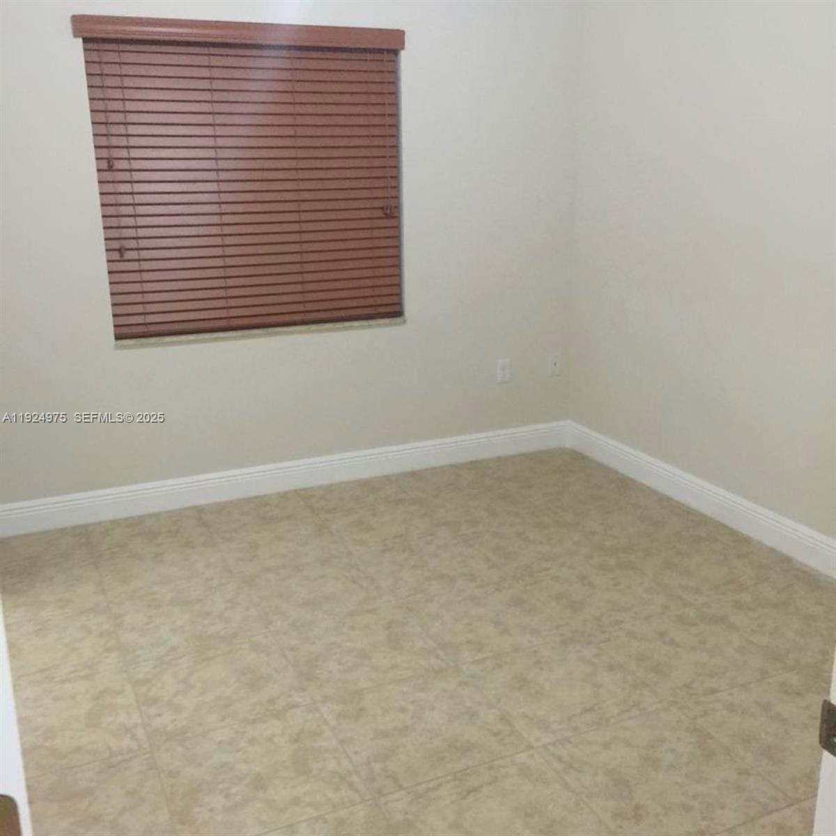 41 West 14th Street, Unit 1 Hialeah, FL 33010 - Photo 10 of 15 an empty room with a window