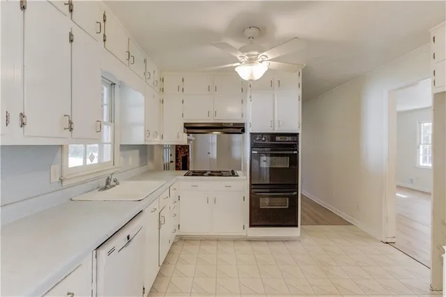 a kitchen with cabinets and window