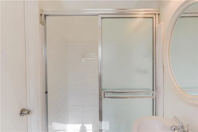 a bathroom with a glass shower door