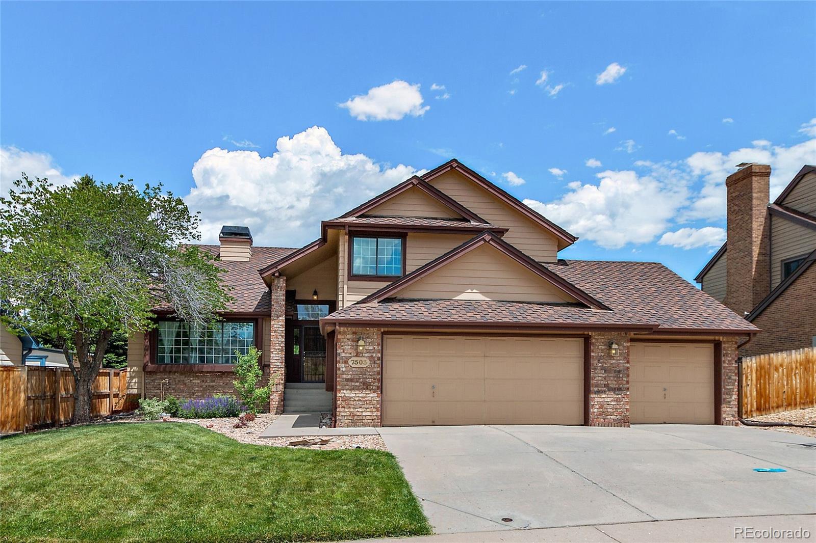 7503 Rattlesnake Drive Lone Tree, CO 80124 - Photo 1 of 29 a front view of a house with a yard and garage