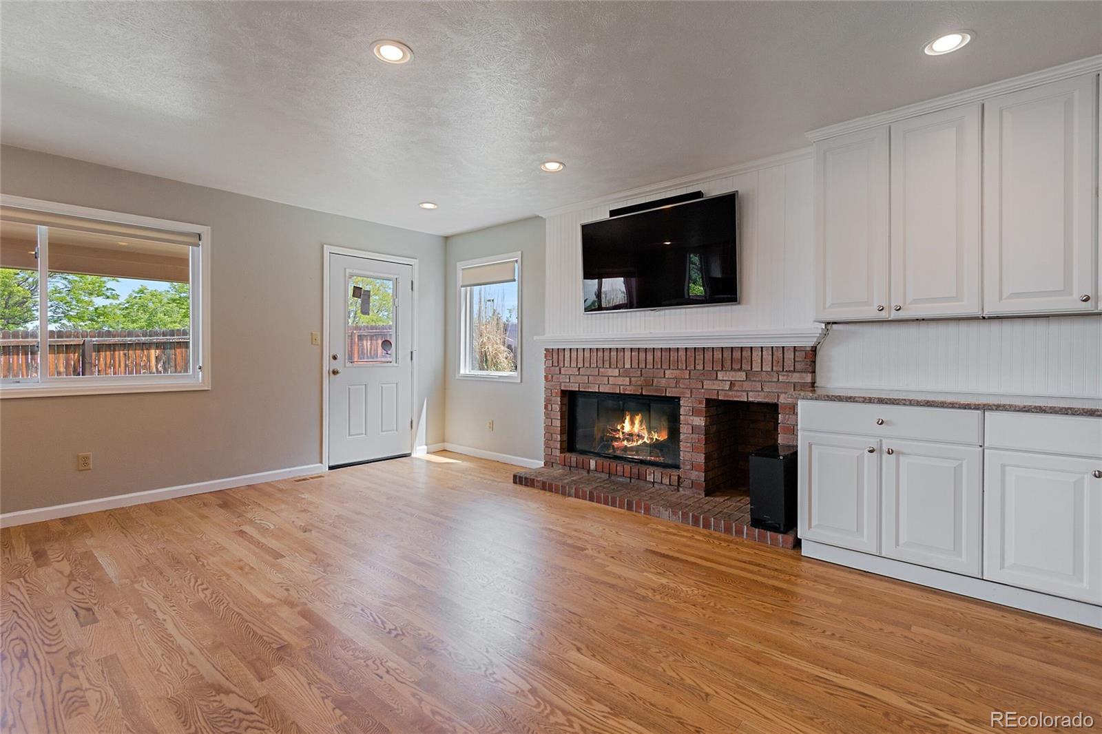 7503 Rattlesnake Drive Lone Tree, CO 80124 - Photo 11 of 29 a view of an empty room with wooden floor fireplace and a window