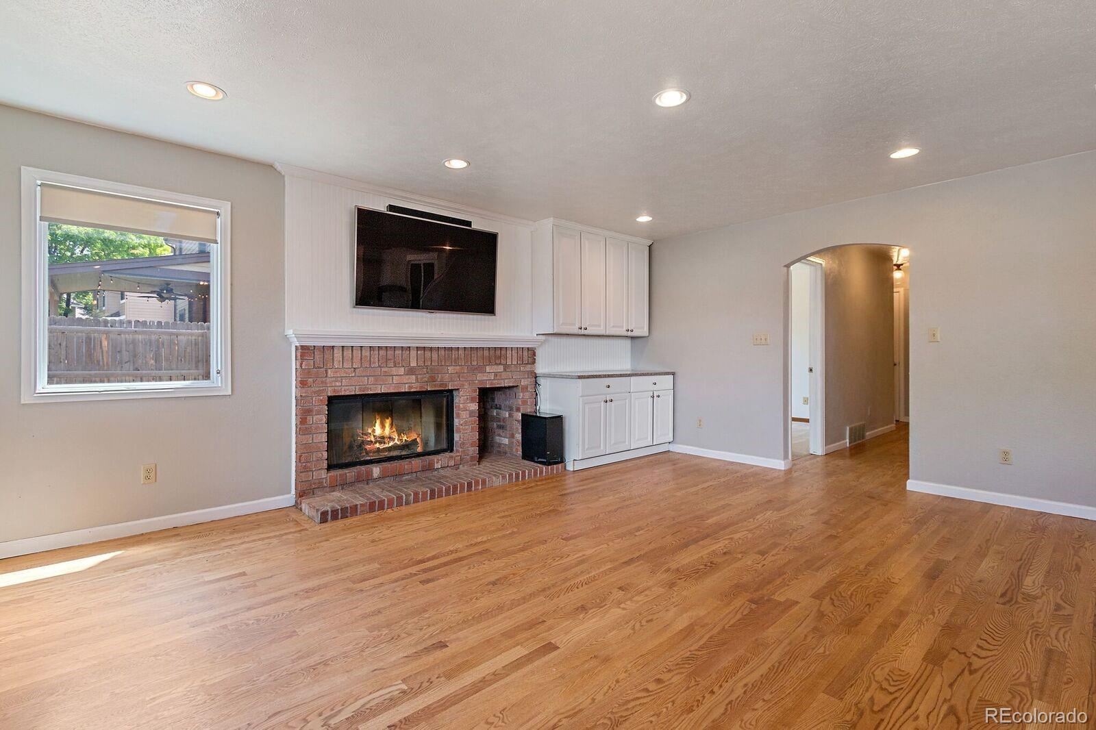 7503 Rattlesnake Drive Lone Tree, CO 80124 - Photo 12 of 29 a view of a livingroom with a fireplace wooden floor and window