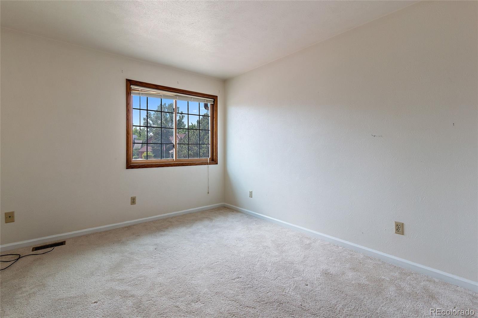 7503 Rattlesnake Drive Lone Tree, CO 80124 - Photo 13 of 29 an empty room with windows