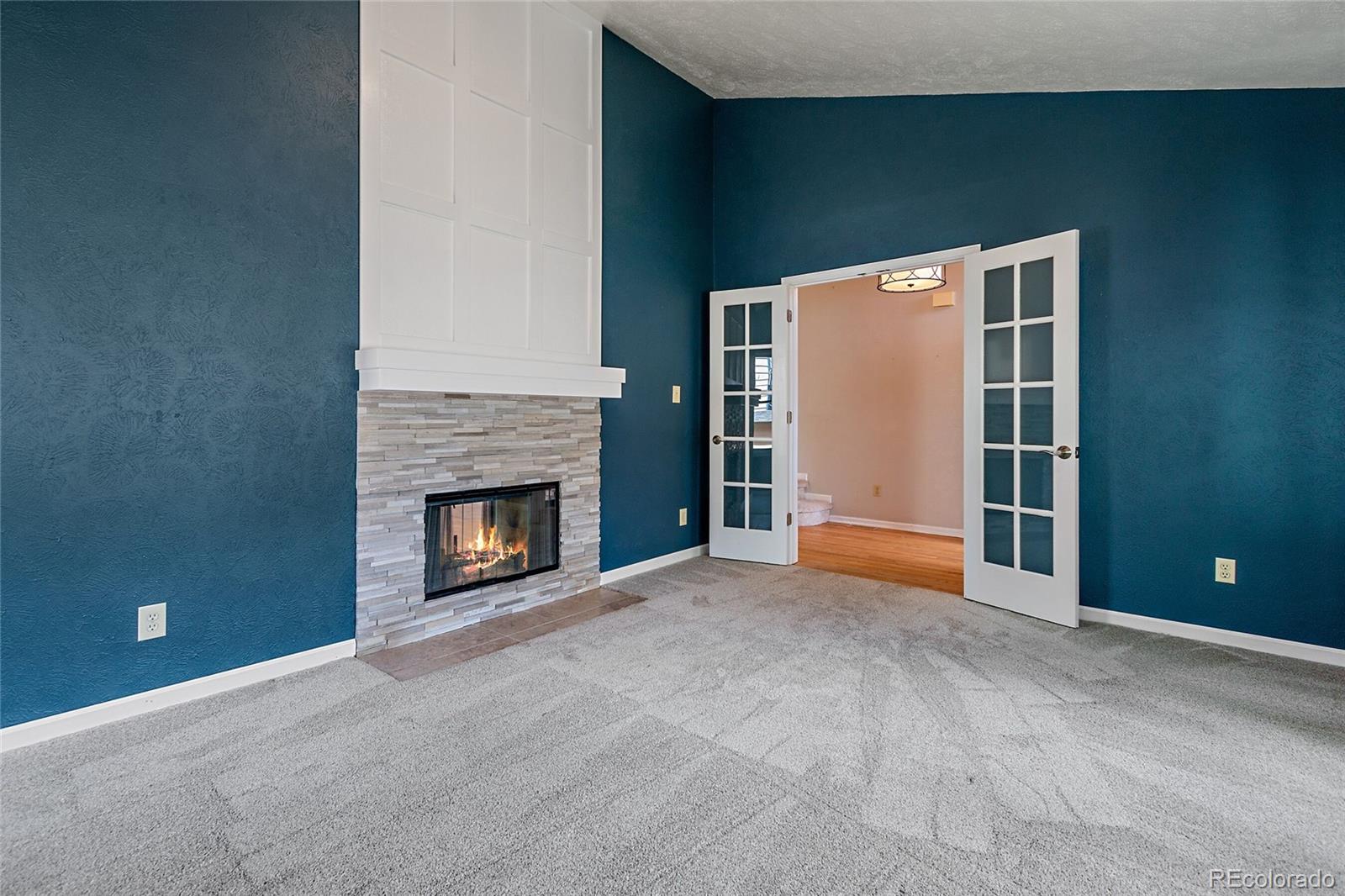 7503 Rattlesnake Drive Lone Tree, CO 80124 - Photo 15 of 29 a view of a livingroom with an empty space and a fireplace
