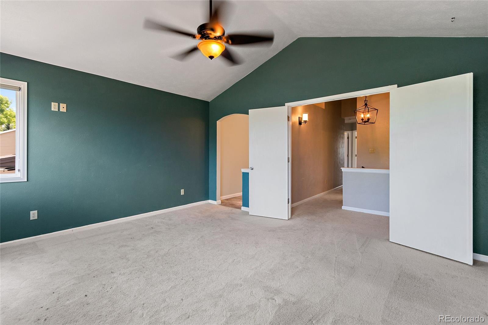 7503 Rattlesnake Drive Lone Tree, CO 80124 - Photo 18 of 29 an empty room with a fireplace and painted walls