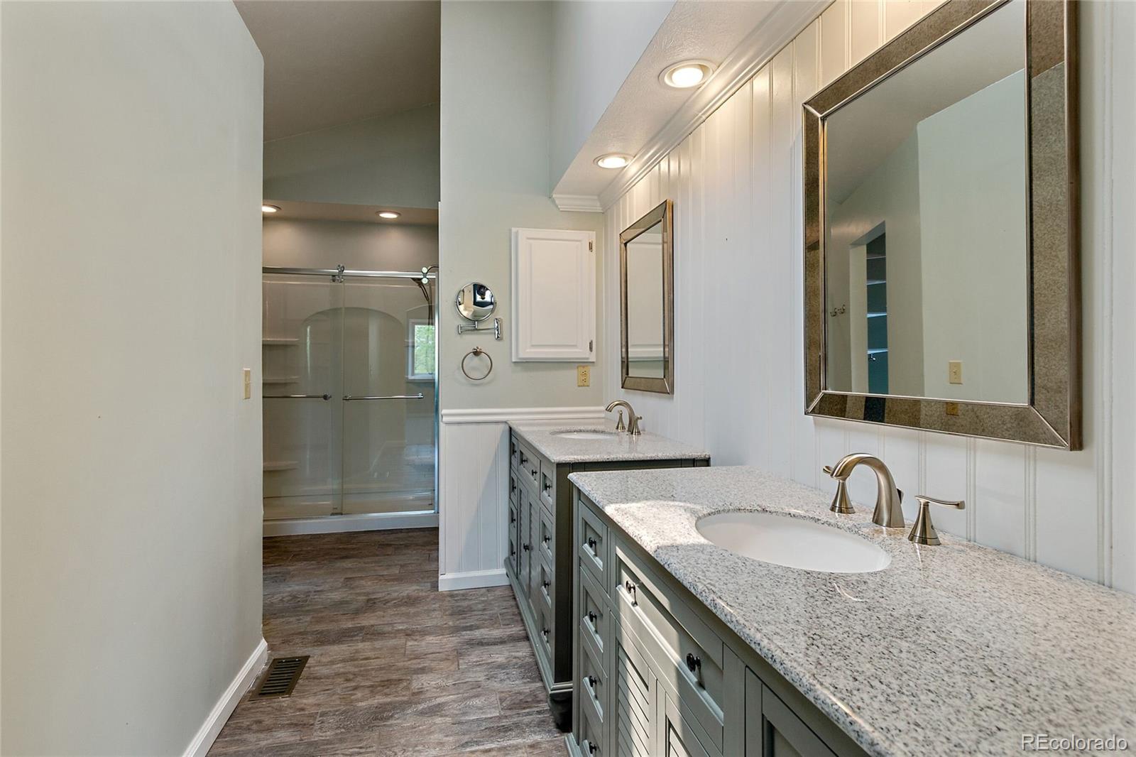 7503 Rattlesnake Drive Lone Tree, CO 80124 - Photo 20 of 29 a bathroom with a granite countertop sink and a mirror
