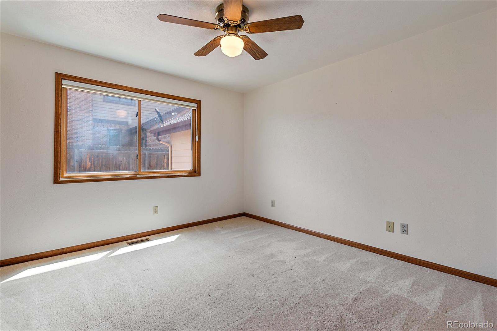 7503 Rattlesnake Drive Lone Tree, CO 80124 - Photo 22 of 29 an empty room with a window and a fan