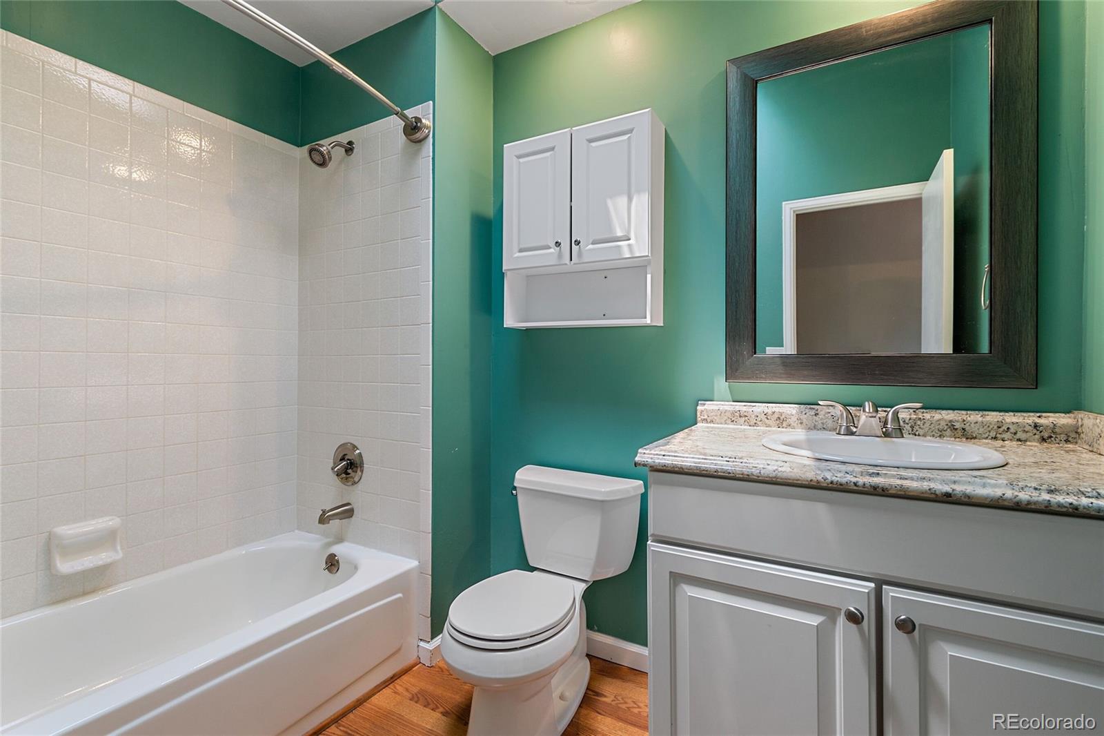 7503 Rattlesnake Drive Lone Tree, CO 80124 - Photo 24 of 29 a bathroom with a granite countertop sink toilet mirror and bathtub