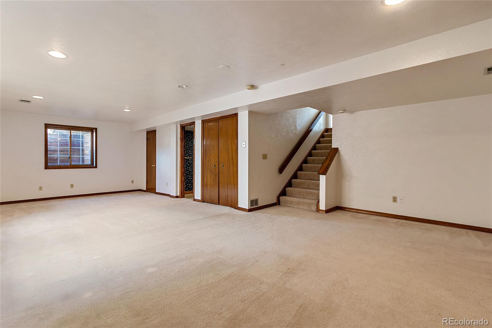 7503 Rattlesnake Drive Lone Tree, CO 80124 - Photo 25 of 29 a view of an empty room with stairs