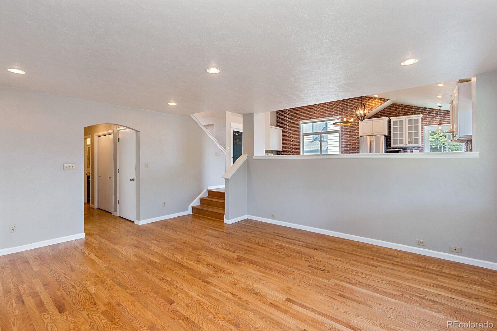 7503 Rattlesnake Drive Lone Tree, CO 80124 - Photo 10 of 29 a view of an empty room with wooden floor and a window