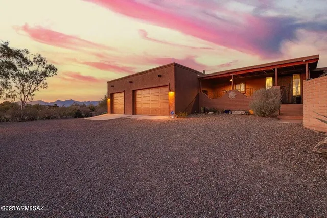 a view of a hallway to a livingroom with furniture and front door