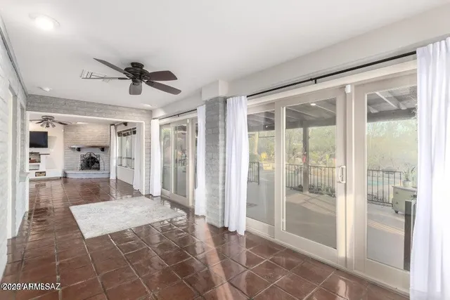 a dining hall with stainless steel appliances kitchen island granite countertop a table chairs and a glass door