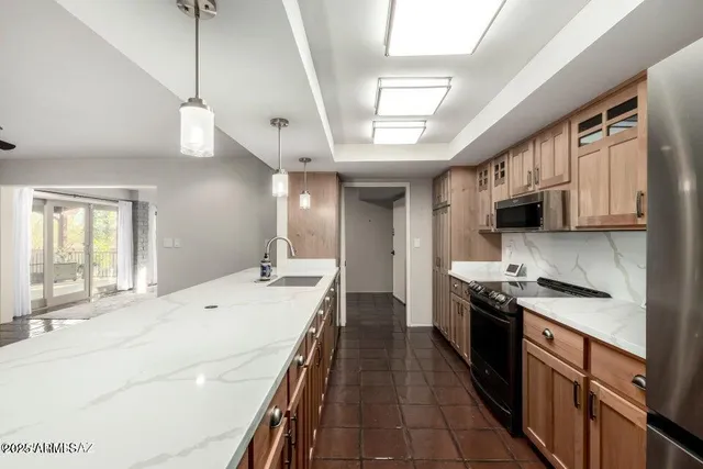 a spacious bedroom with a bed and a chandelier