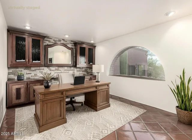 a dining room with furniture a large window and a chandelier