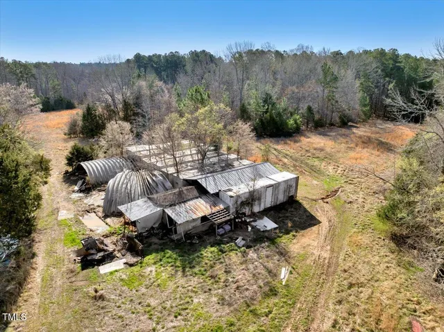 an aerial view of a house with a yard and lake view