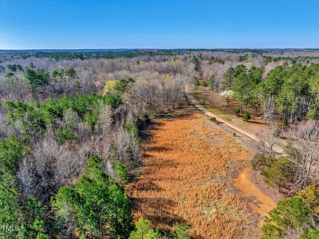 a view of a swimming pool with a patio and a yard