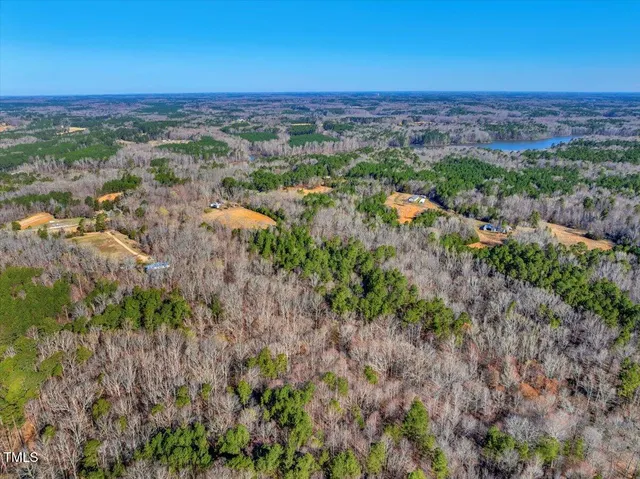an aerial view of a houses with a lake view