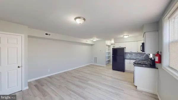 a view of kitchen appliances and wooden floor