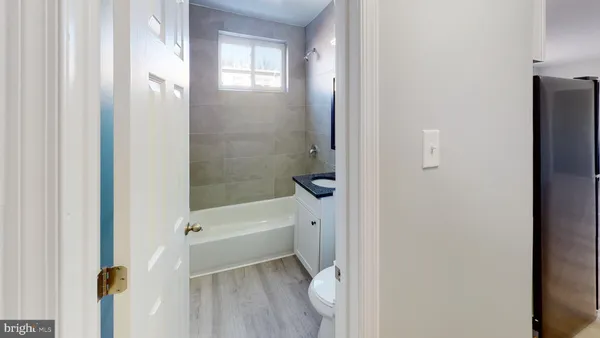 a bathroom with a tub shower and a sink