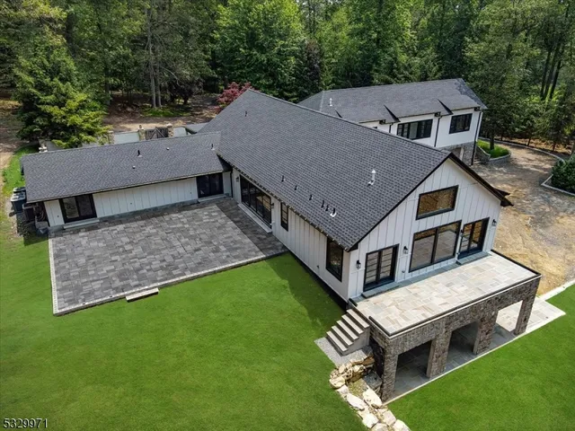 an aerial view of a house with a big yard