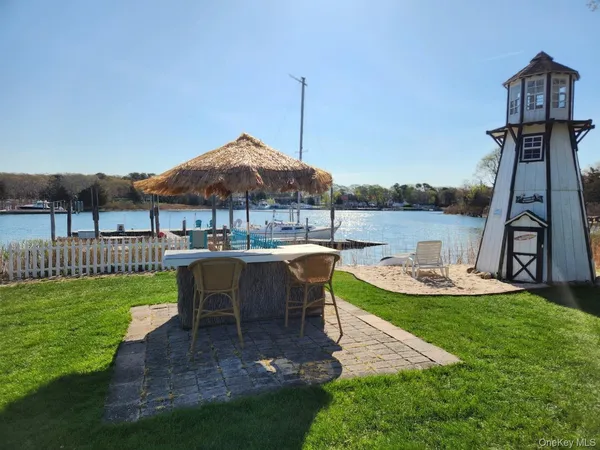 a view of a house with backyard and sitting area