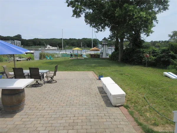 a view of a swimming pool and lounge chairs in back of the house