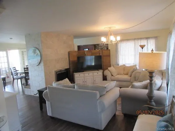 a living room with furniture and a chandelier