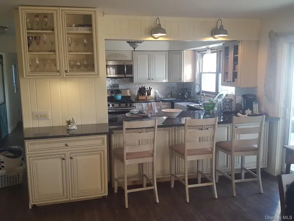 a kitchen with cabinets and chairs